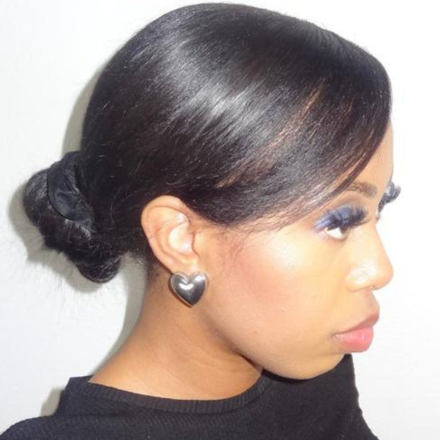 Woman wearing Silver Heart Clip-On Earrings by Clipped by Devon side profile view sleek bun hairstyle comfortable no piercing clip-on earrings for unpierced ears